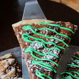 Thin Mint dessert pizza slice - Nutella base, mint chocolate cookies, mint icing and chocolate drizzle - Brother Bruno Direct