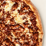 Close-up of Brother Bruno BBQ Chicken Pizza with barbecue-coated breaded chicken and melted cheese